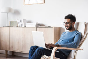 man using laptop computer at home